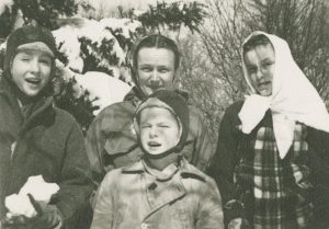 Black and white photograph of a woman with her three children
