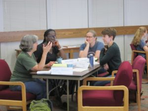 Four instructors discussing draft assignments at a WAC workshop for science instructors at UW-Madison, August 8, 2018.