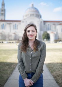 Rachel de Rosset smiles in front of a large white domed building.