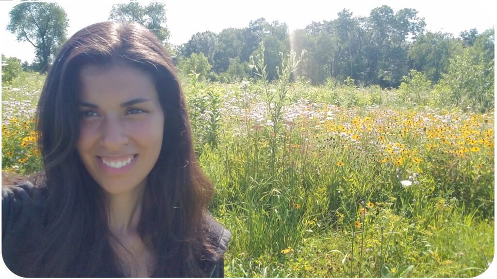 Mia with field of wildflowers