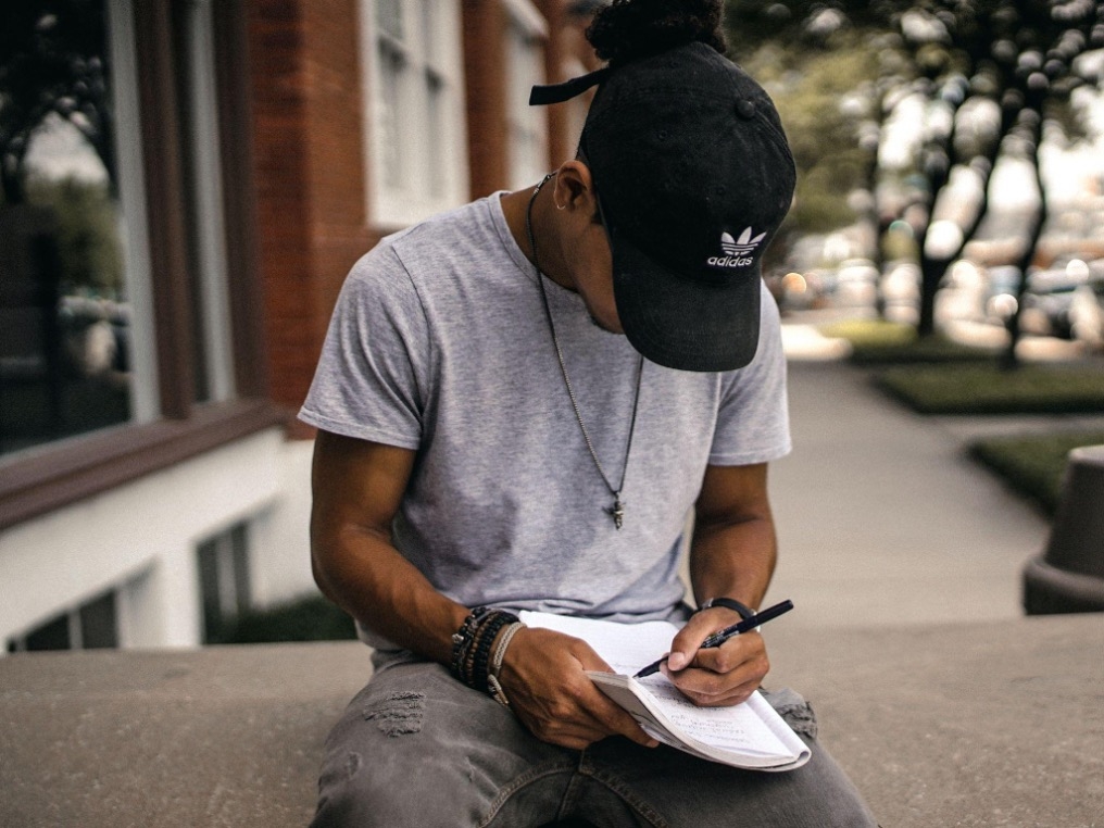 Black man writing in notebook