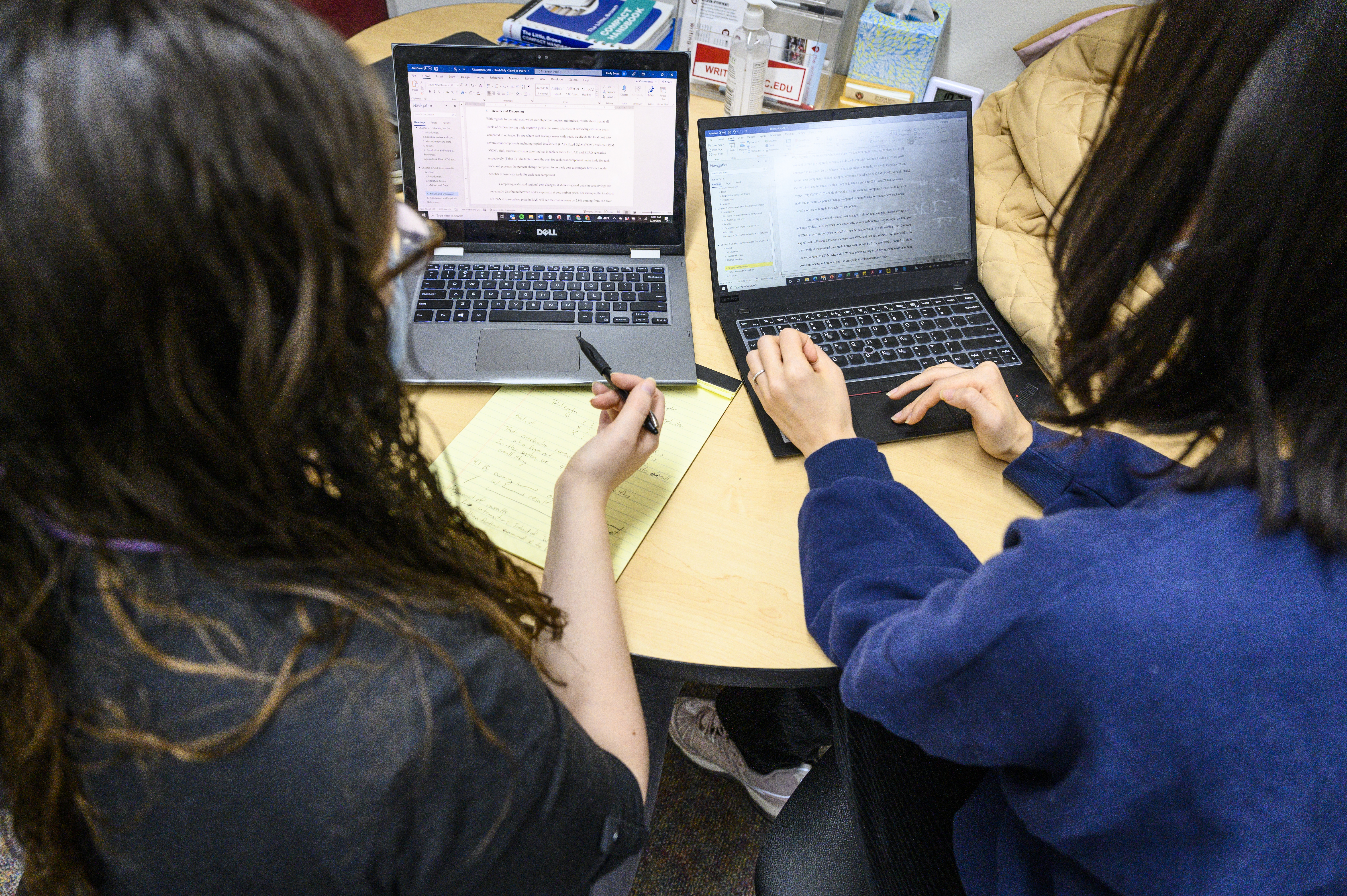 Emily Bouza (Writing Center TA at left) helps Herein Kim, a graduate student with her writing in the Writing Center in Helen C. White Hall at the University of Wisconsin-Madison on March 21, 2022. 