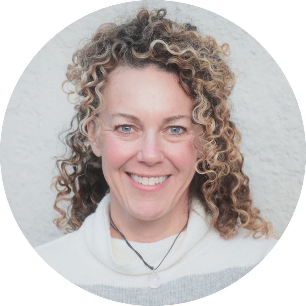 Susanne Treiber a white woman with curly hair smiling widely against a white background