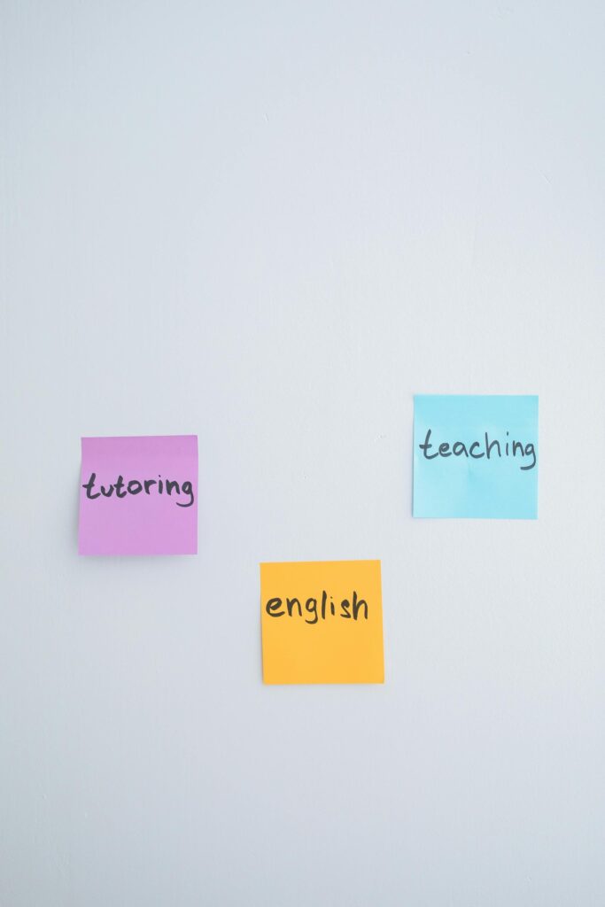 Three notes on a white canvas with the words, “tutoring” in purple,“teaching” in blue, and “english” in yellow.