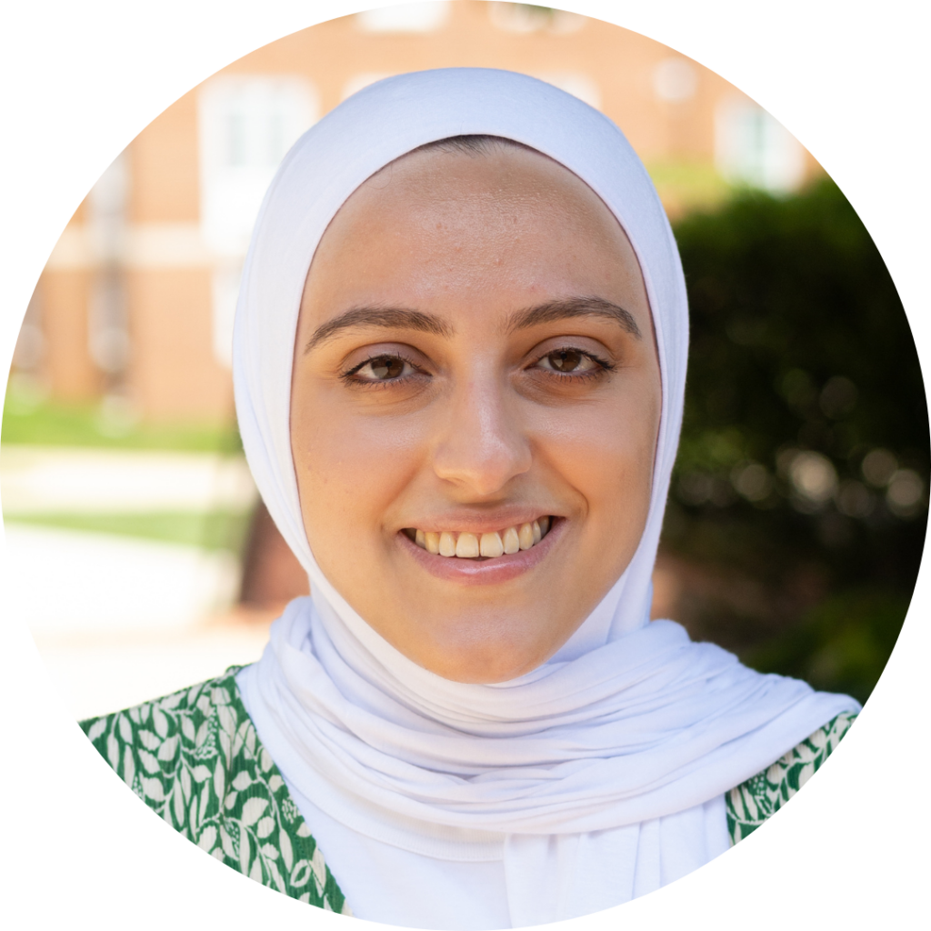 Rasha, a woman smiling and wearing the hijab.