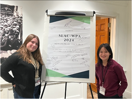 Two Lafayette students stand in front of a poster at the SLAC-WPA conference