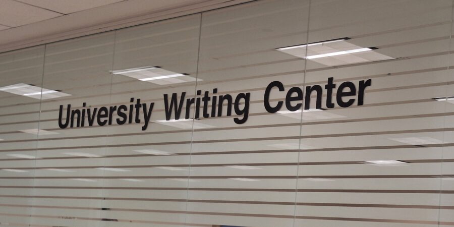 A frosted glass window with the words University Writing Center in black text.