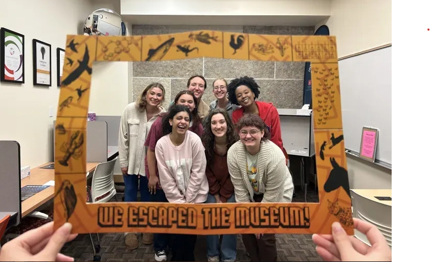 Undergraduate writing tutors posing together after completing an activity.