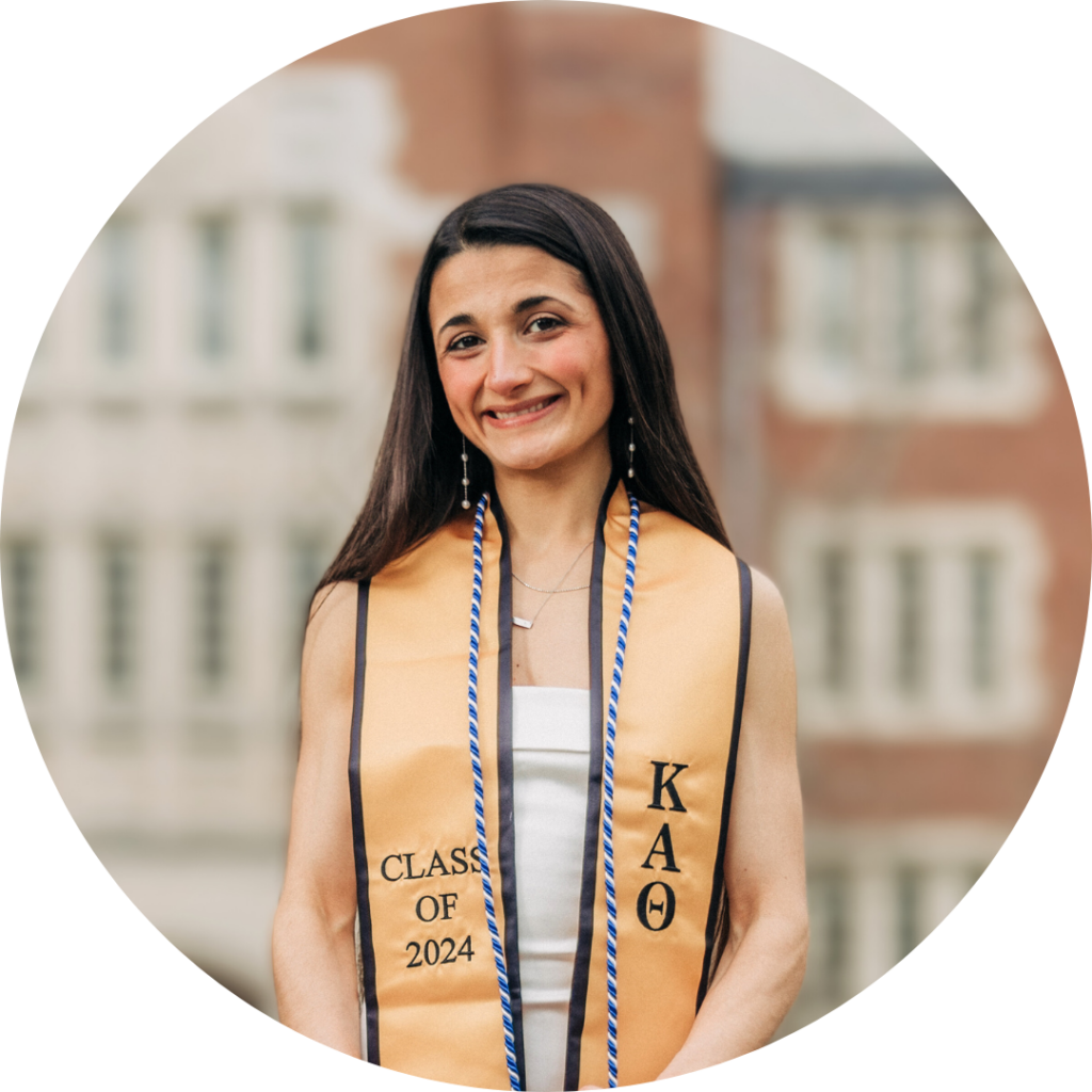 The author, Melisa Mansuroglu, wearing graduation regalia and smiling widely.