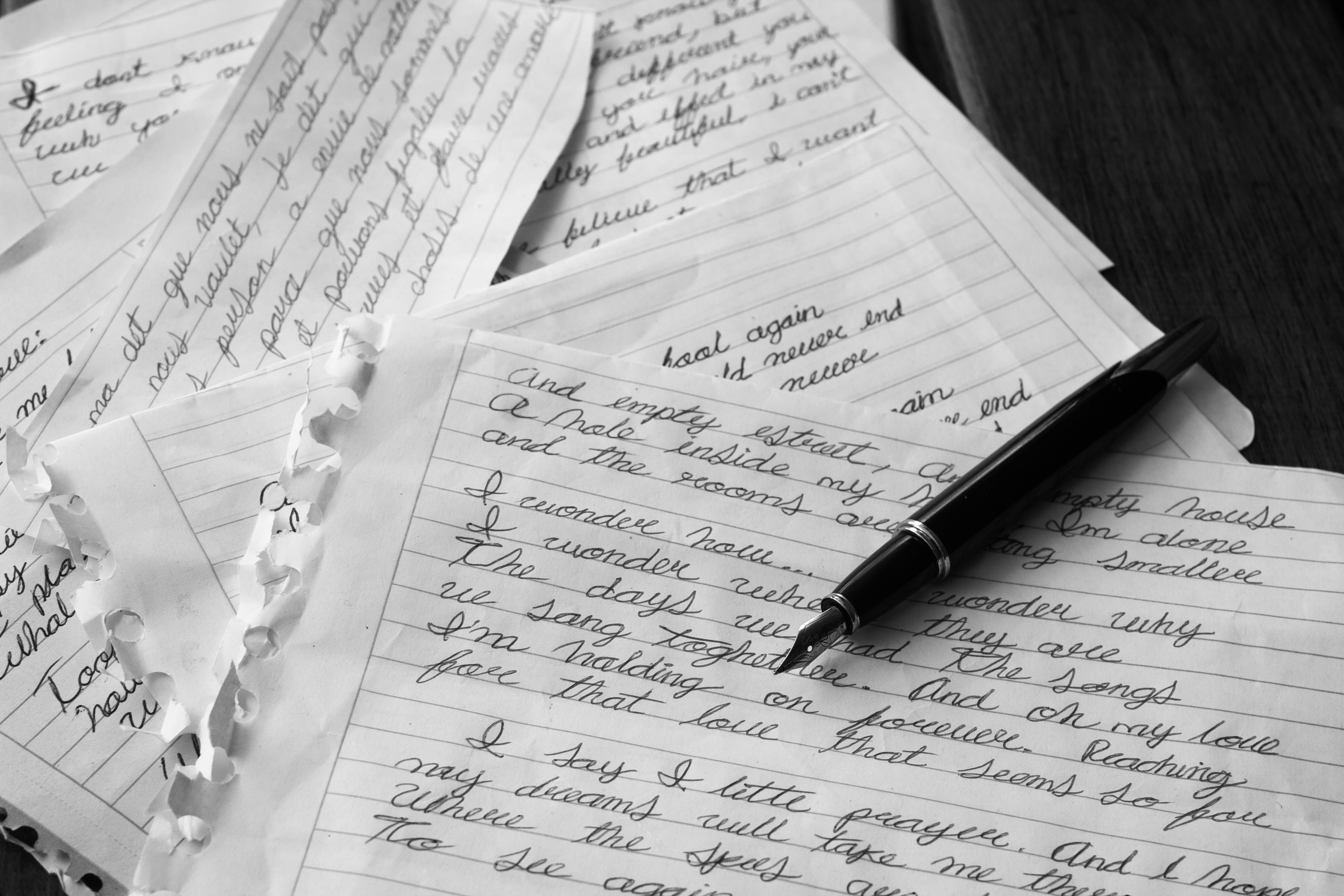 handwritten letters in ink pen on lined paper