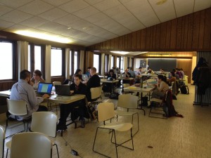 Graduate students sitting at tables working during a writing retreat. 