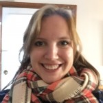 Leah Pope, the author, smiling widely with a thick scarf around her neck.