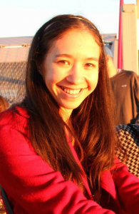 Erica wearing a red jacket and smiling