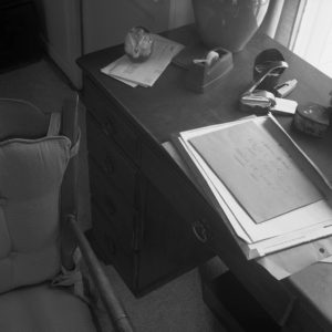 Detail of desk surface with a pile of handwritten letters and envelopes. 