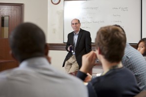 John Duffy standing in front of a classroom filled with students